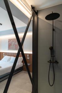 a room with a bed and a glass door with a shower at Villa D'Orville luxury suites Taormina in Taormina