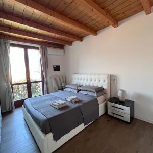 a bedroom with a large bed and a large window at VILLA LIDO - Lake Como in Colico +44 photos