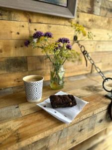 a piece of cake and a cup of coffee on a table at The Annex, Westerlands, Graffham in Graffham