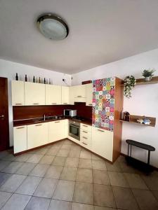 a kitchen with white cabinets and a sink at Casa Victoria - Bellagio in Bellagio