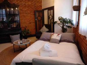 a bed in a room with a couch and a table at The Old Chocolate Shop in Canowindra