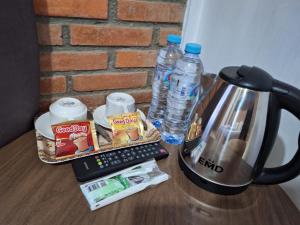 a table with a tea kettle and bottles of water at MIN Guest House Watukarung in Pacitan +32 photos