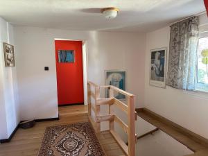 a room with a staircase and a red door at Monteurshaus im Leipziger Süde nähe A38 in Leipzig