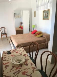 una camera da letto con due letti, un tavolo e delle sedie di Agriturismo Eolo a Taranto