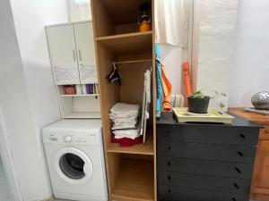 a laundry room with a washing machine and a washer at Rustic apartment close to the beach of Alcalá! in Alcalá