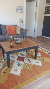 a living room with a coffee table on a rug at Semiramis Urla Guesthouse in Urla