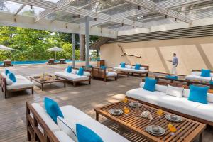 a living room with blue and white furniture and a pool at Taj Exotica Resort & Spa, Andamans in Havelock Island