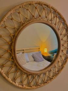 a mirror with a bed in a room at Executive Studio Clara by House of Cleo in Manila