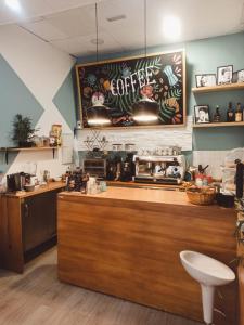 a kitchen with a counter with a coffee shop at Pensión Duquesa Bed & Breakfast in Granada