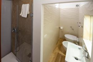 a bathroom with a shower and a toilet and a sink at A due passi dal Duomo in Cefalù +2 photos