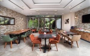 a restaurant with tables and chairs in a room at Recital Park Hotel in Istanbul