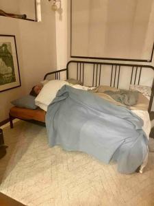 a person sleeping in a bed with a blanket at Chic Loft Style Apartment in Perth