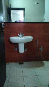 a bathroom with a sink and a mirror at Tulips Misty hights 2BHK villa in Yelagiri