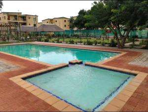 uma grande piscina com água azul em Exquisite short and long stay em Gaborone