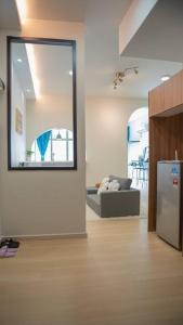 a living room with a couch and a mirror at Mount Austin #Palazio B1 Studio Modern Cozy 1-2Pax #MSPro in Johor Bahru +25 photos