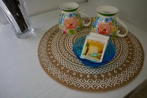 a plate with two vases on top of a table at Aria di sale B&B in Marina di Strongoli