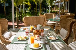 a table with food and drinks on top at The Westin Porto de Galinhas All-Inclusive in Porto De Galinhas