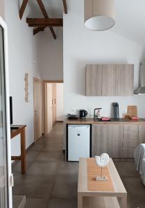 a living room with a table and a kitchen at Niki Apartments Beach Loft in Platamonas