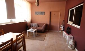 a living room with a couch and a table at Petra Bed & Breakfast in Wadi Musa