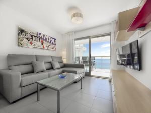 a living room with a couch and a view of the ocean at Apartamentos Hipocampos Calpe Rent Apart in Calpe