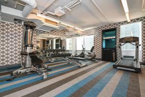 a fitness room with treadmills and cardio machines at Aloft Charlotte City Center in Charlotte