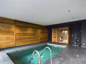 a swimming pool in a house with wooden walls at Chalet Montvalezan-La Rosière, 6 pièces, 10 personnes - FR-1-398-633 in Montvalezan