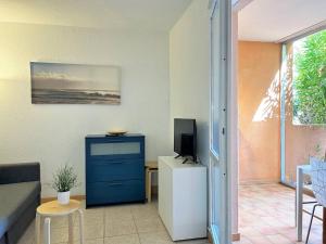 un salon avec une commode bleue et une télévision dans l'établissement Appartement Bormes-les-Mimosas, 2 pièces, 4 personnes - FR-1-251-436, à Bormes-les-Mimosas