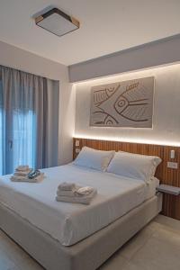 a bedroom with a large bed with towels on it at Villa D'Orville luxury suites Taormina in Taormina