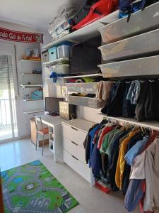 a closet with white drawers and a desk at Casa María in Gabia la Chica