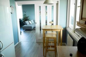 a kitchen with a table and a living room at 5 minutes to downtown Arendal in Arendal