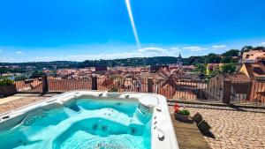 a hot tub on a patio with a view of a city at Romantik Hotel Burgkeller Residenz Kerstinghaus in Meißen