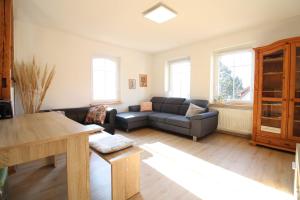 a living room with a couch and a table at Schwarzwaldblick in Schramberg