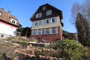 a large house with a pond in front of it at Schwarzwaldblick in Schramberg