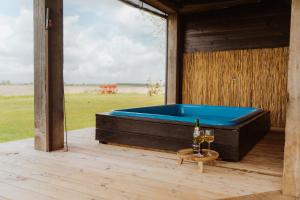a pool table on the deck of a house at Tiny Farm House met hot tub. in Menaldum