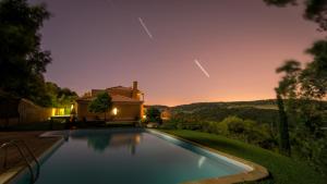 a swimming pool in front of a house at Enjoy Arrábida Natural Park in Palmela