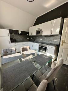 a kitchen with a glass table and two chairs at Villa Blumenthal in Ludwigslust