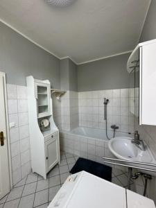 a bathroom with a sink and a bath tub at Villa Blumenthal in Ludwigslust