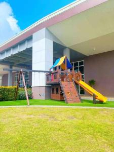 a playground in front of a building with a slide at Scandinavian Room at Wind Residences in Tagaytay