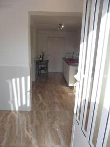 a room with a kitchen with a table and a door at Lovely 1 bedroom attached apartment with kitchen but private with seasonable pool in Albox