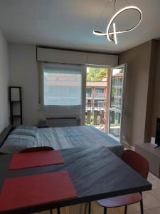 a bedroom with a large bed and a large window at Foresteria Hostaria Del Golfo cod struttura C00025 in Laveno-Mombello