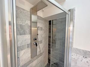 a shower with a glass door in a bathroom at Camere in Centro in Cagliari