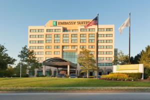 a building with two flags on top of it at Embassy Suites by Hilton Boston Waltham in Waltham