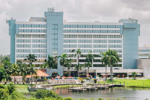 a large blue building with boats in a body of water at Hilton Palm Beach PBI in West Palm Beach