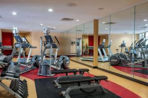 a gym with several tread machines and mirrors at Wyndham Noblesville in Noblesville