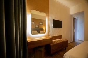 a hotel room with a mirror and a bed at FALIREON HOTEL in Athens