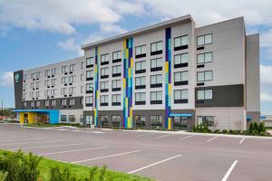 a large white building with a parking lot at Tru By Hilton Toronto Airport West in Mississauga