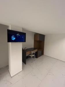 an empty room with a desk and a tv on a wall at Comfort Hotel in Struga