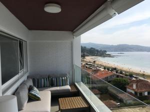 a living room with a couch and a view of the beach at Mirando al Mar. Playa America in Nigrán