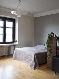 a white bedroom with a bed and a window at Rautatienkatu 13 B in Lahti