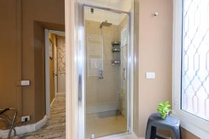 a shower with a glass door in a bathroom at A-Rome Suite in Rome